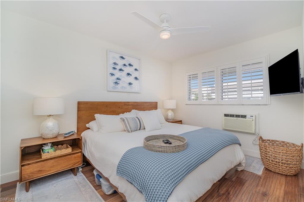 473 12th Avenue South, Unit B11 Naples, FL 34102 - Photo 8 of 18 a bedroom with a bed and flat screen tv