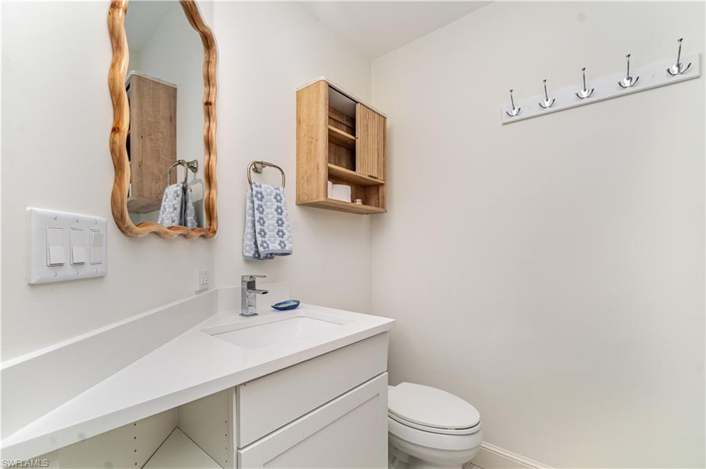 473 12th Avenue South, Unit B11 Naples, FL 34102 - Photo 10 of 18 a bathroom with a sink a toilet and mirror