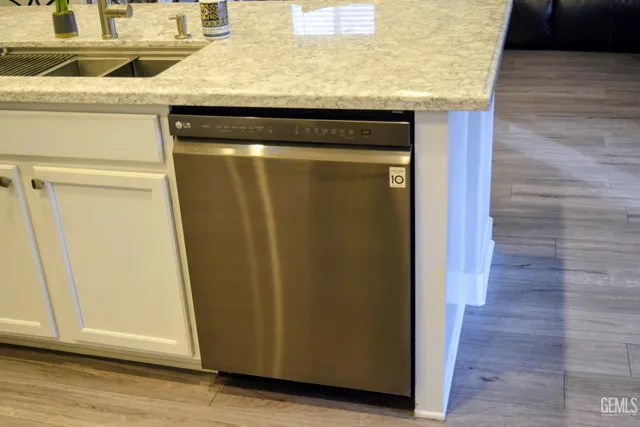 a view of a door and an empty room with wooden floor