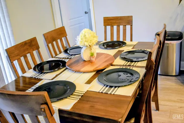 a dining room with furniture and wooden floor