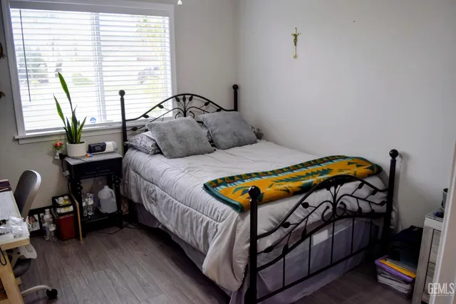 a bedroom with a bed and a chair