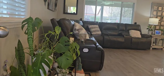 a living room with furniture and a potted plant