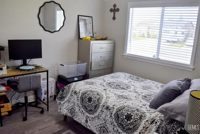 a bedroom with a bed and a window