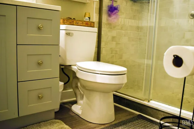 a bathroom with a toilet and a shower