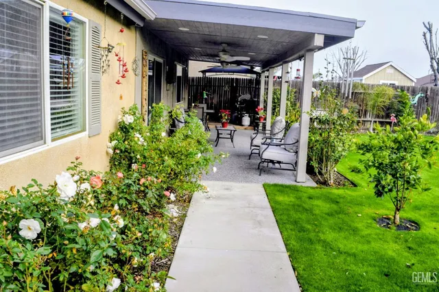 a view of a patio with table and chairs potted plants