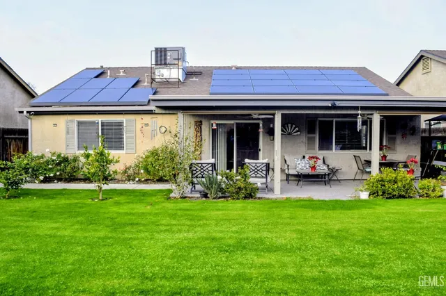 a view of a house with sitting area and garden