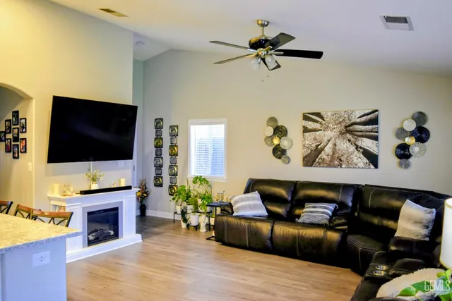 a living room with furniture fireplace and flat screen tv