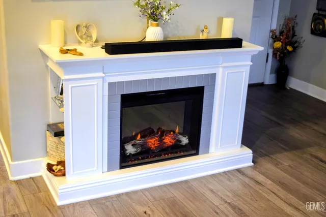 a living room with a fireplace and wooden floor