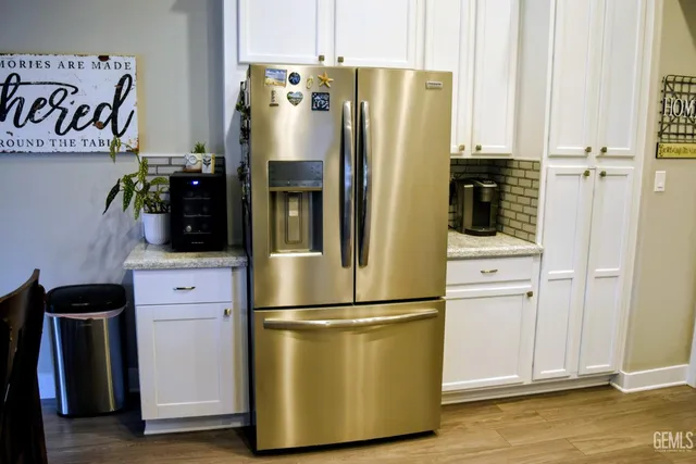 a kitchen with stainless steel appliances a refrigerator sink and cabinets