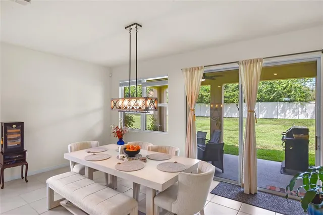 a view of a dining room filled furniture and chandelier