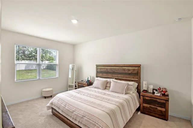 a bedroom with a bed and window