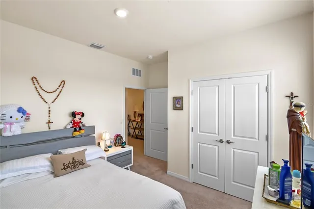 a bedroom with a bed and a dresser