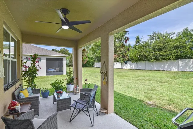 a view of a porch with furniture and a yard