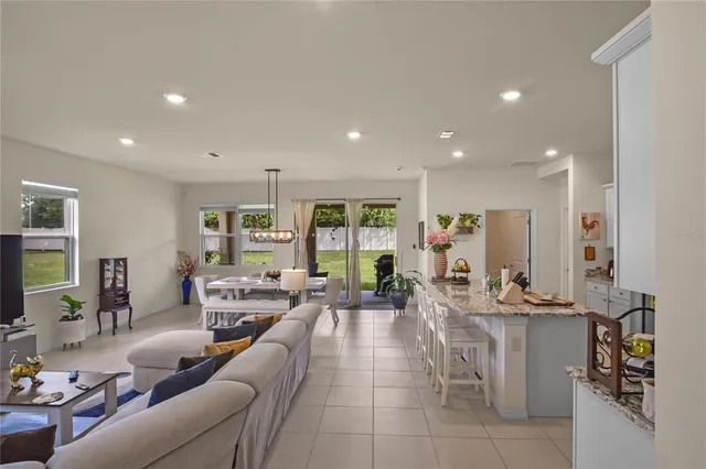 a living room with furniture large window and flat screen tv