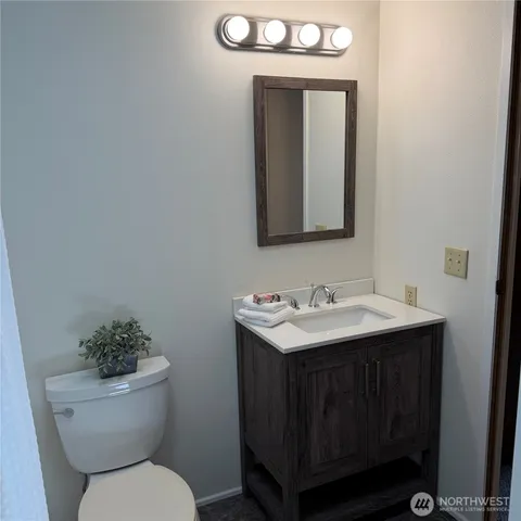 a bathroom with a toilet sink and mirror