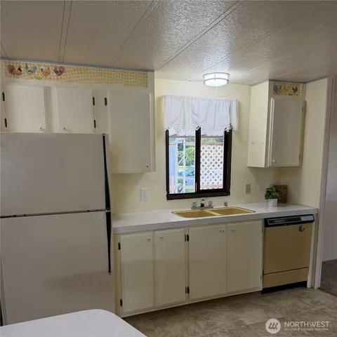 a kitchen with a refrigerator a sink and dishwasher