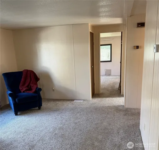 a living room with furniture and a mirror