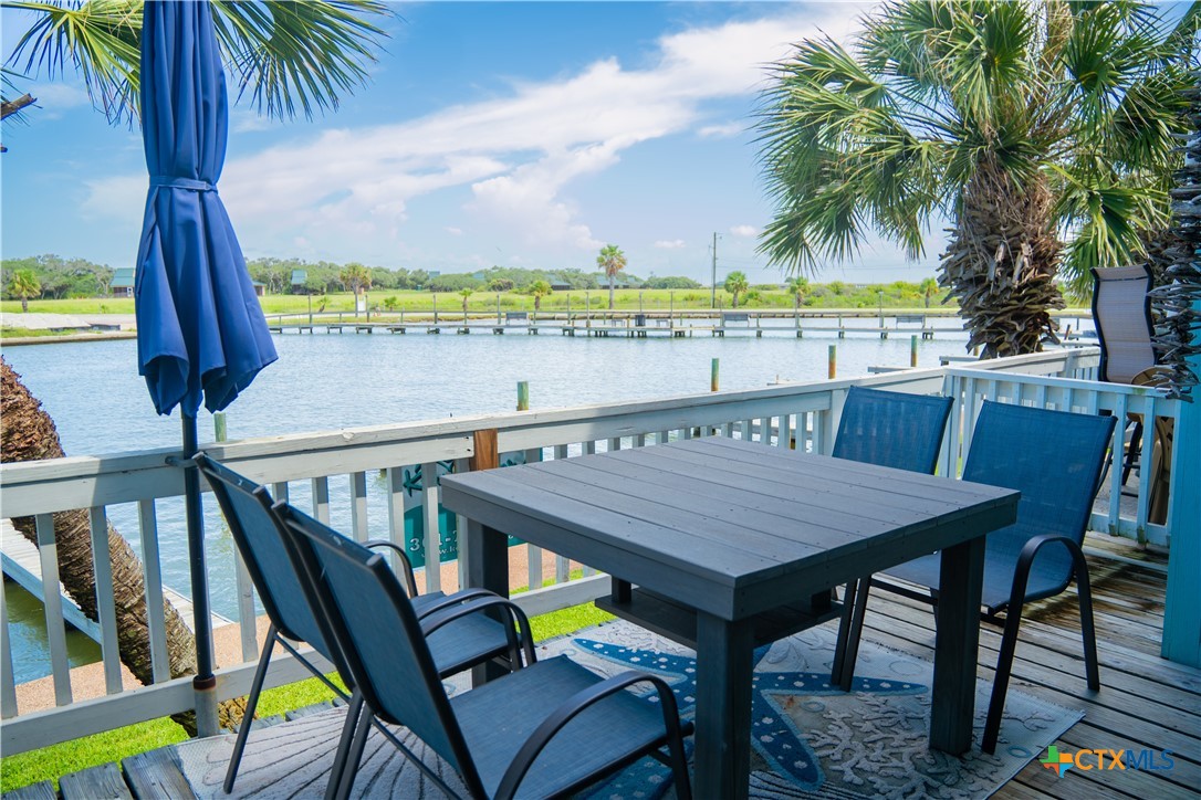 2292 North Fulton Beach Road, Unit 505 Rockport, TX 78382 - Photo 42 of 46 a view of a table and chairs in patio of the house