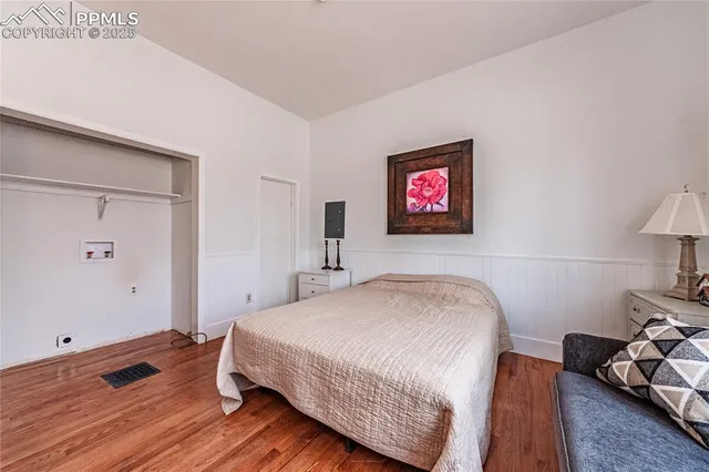 a kitchen with stainless steel appliances granite countertop a stove top oven a sink and dishwasher a refrigerator with wooden floor