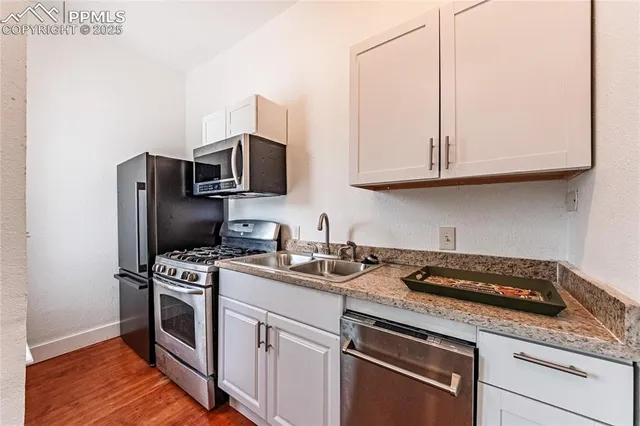 a view of a hallway with furniture and wooden floor