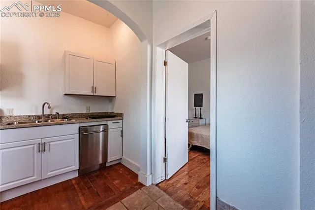 a living room with furniture and kitchen view