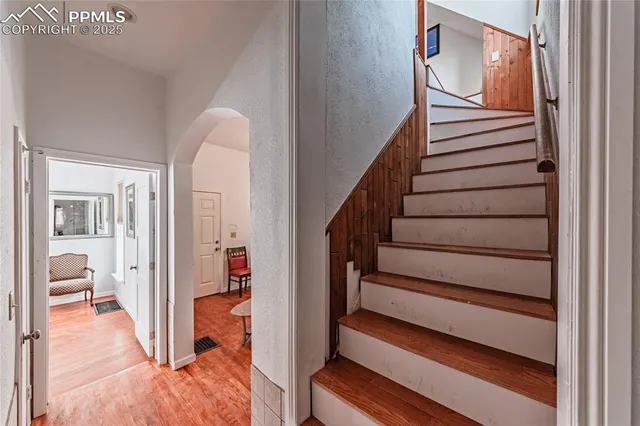 a living room with furniture and a hard wood floor