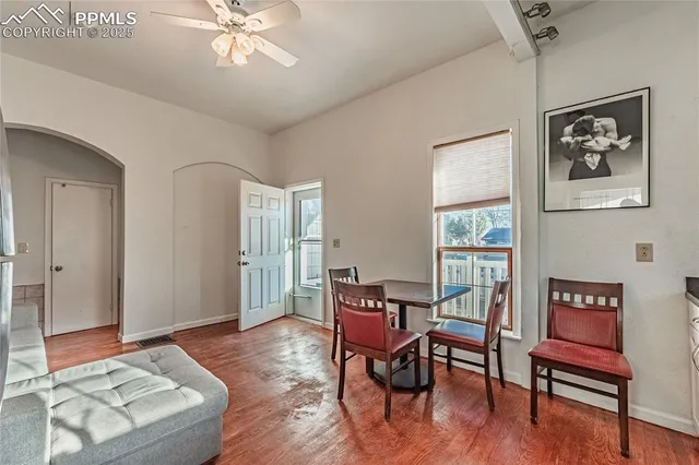 a living room with furniture and kitchen view