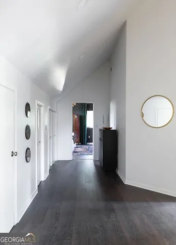 a living room with a table chairs and a chandelier