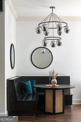 a living room with furniture stairs and a window