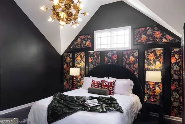 a bedroom with a bed and painting on the wall