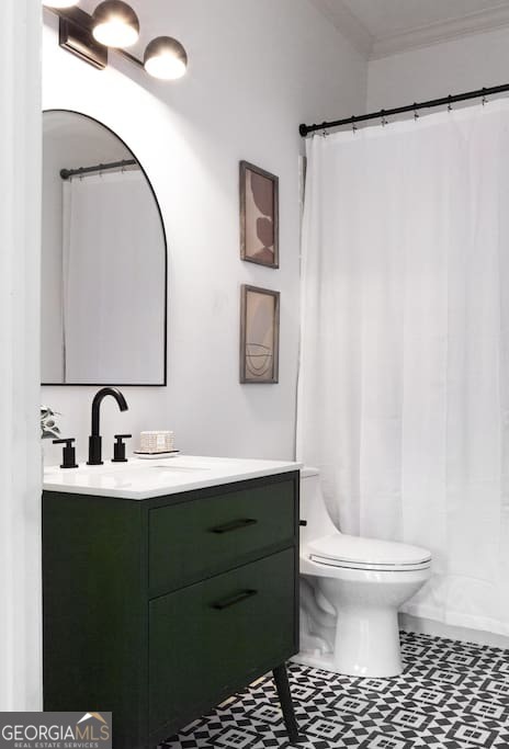 201 Hurt Street Northeast, Unit ENTIRE Atlanta, GA 30307 - Photo 31 of 61 a bathroom with a sink toilet and mirror