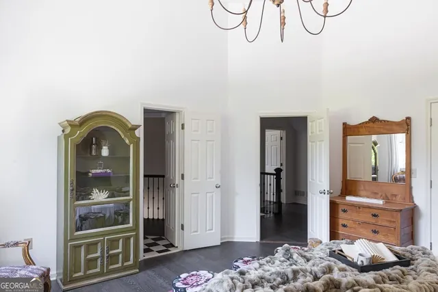 a bedroom with a bed and a painting on the wall