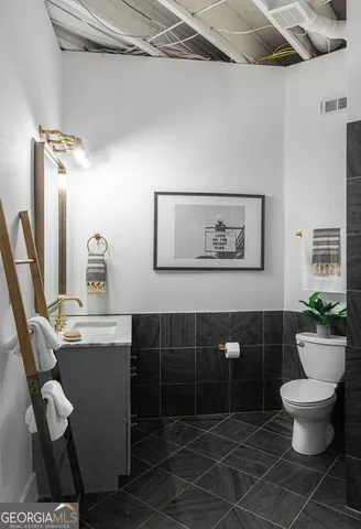 a kitchen with stainless steel appliances granite countertop a sink refrigerator and cabinets