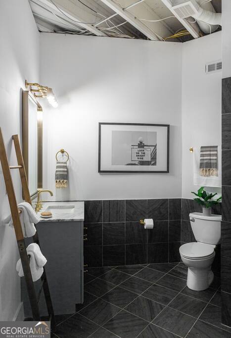 201 Hurt Street Northeast, Unit ENTIRE Atlanta, GA 30307 - Photo 41 of 61 a bathroom with a sink mirror and toilet