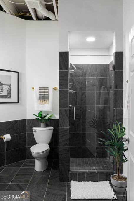 201 Hurt Street Northeast, Unit ENTIRE Atlanta, GA 30307 - Photo 52 of 61 a bathroom with a toilet and a shower