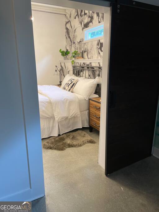 201 Hurt Street Northeast, Unit ENTIRE Atlanta, GA 30307 - Photo 54 of 61 a bed sitting in a bedroom next to a window