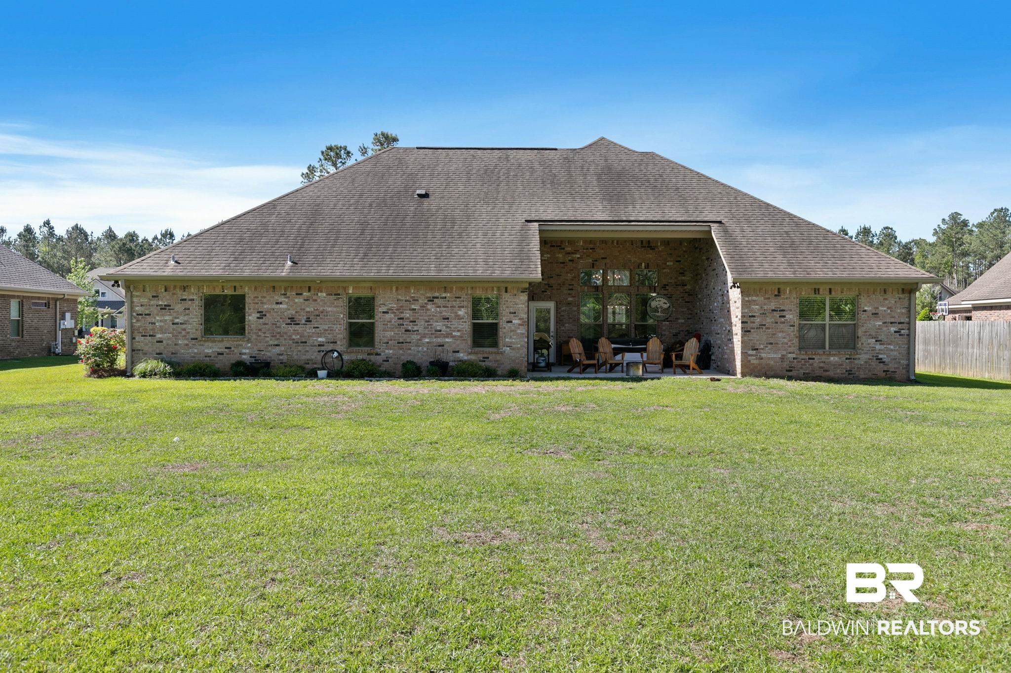 31911 Bobwhite Road Daphne, AL 36527 - Photo 51 of 85 Rear view of property with a patio, a lawn, brick siding, and roof with shingles