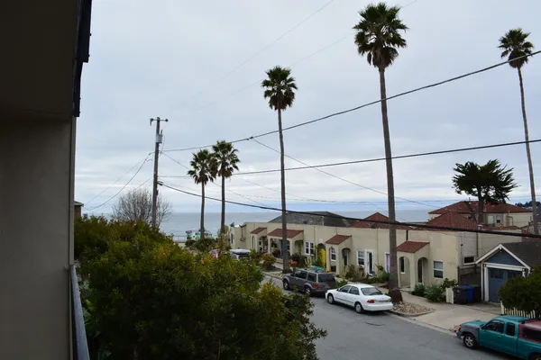 a view of a city street and car parked