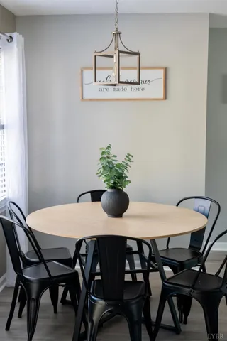 a dining room with furniture and window