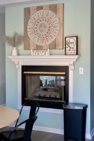 a fireplace with a clock on wall