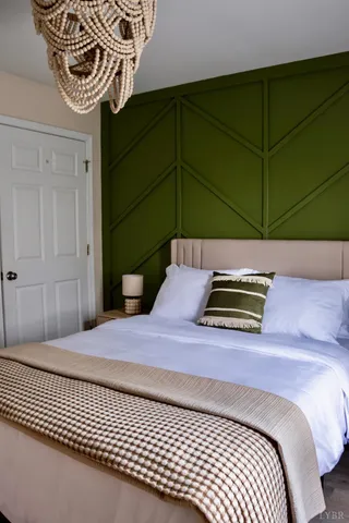 a bedroom with a bed and a chair