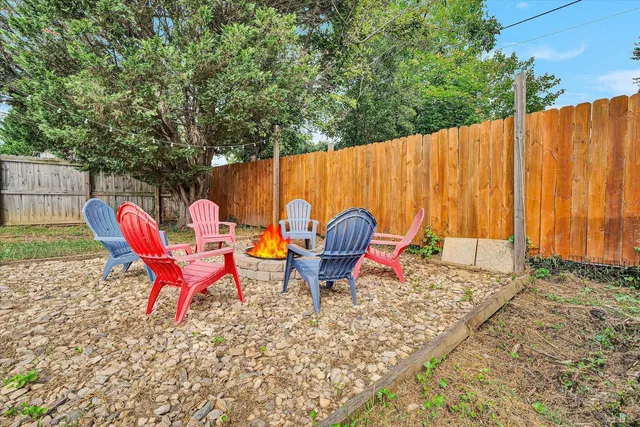 a backyard of a house with table and chairs
