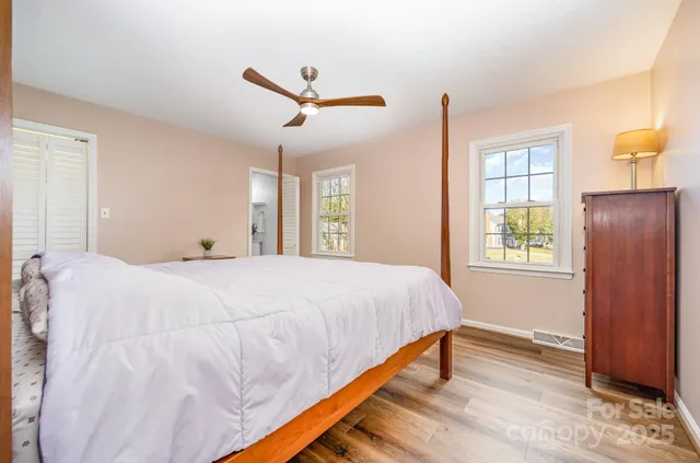 a bathroom with a granite countertop toilet sink and mirror