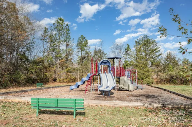 a view of a house with a backyard and a trees
