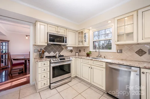 a kitchen with stainless steel appliances granite countertop a stove and a sink