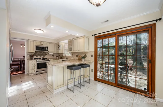 a view of kitchen with microwave and cabinets