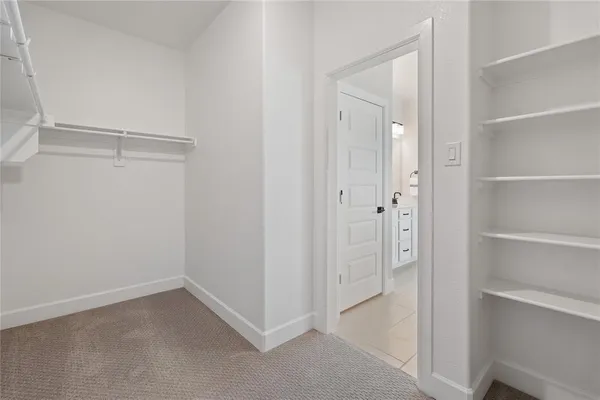 a bedroom with a bed and dresser with mirror