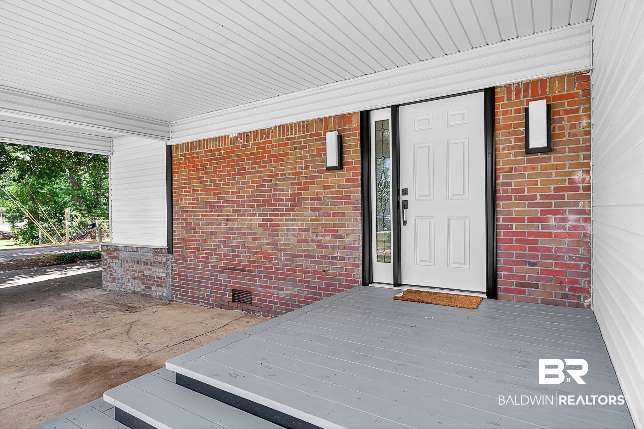101 Terry Avenue Brewton, AL 36426 - Photo 9 of 48 View of exterior entry featuring crawl space, covered porch, and brick siding