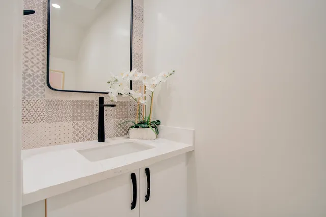 a bathroom with a sink and a mirror