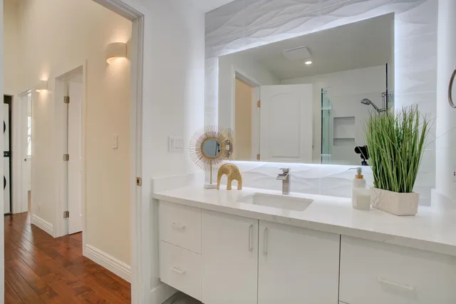 a bathroom with a double vanity sink and a mirror